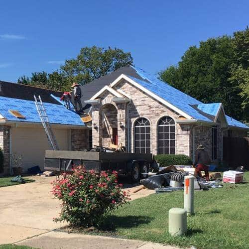 Roofers replace roof.