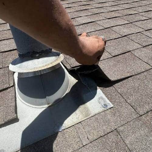 Roofer inspects roof.