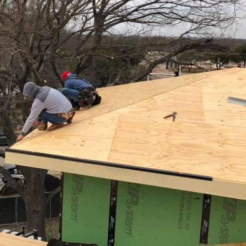 Roofers install roof.
