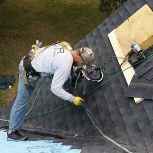 Roofer repairs roof.